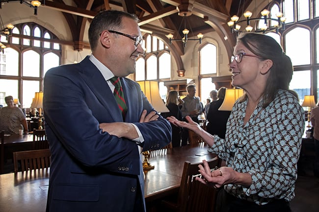 Andrew D. Martin talks with a guest in the Law Library