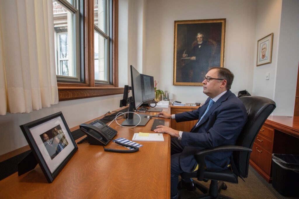 Andrew D. Martin at his desk, working on the computer