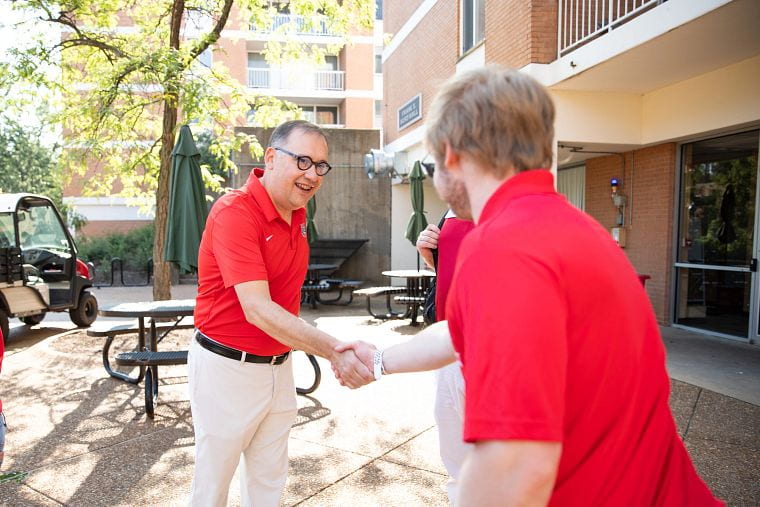 Chancellor Martin greeting an undergraduate student