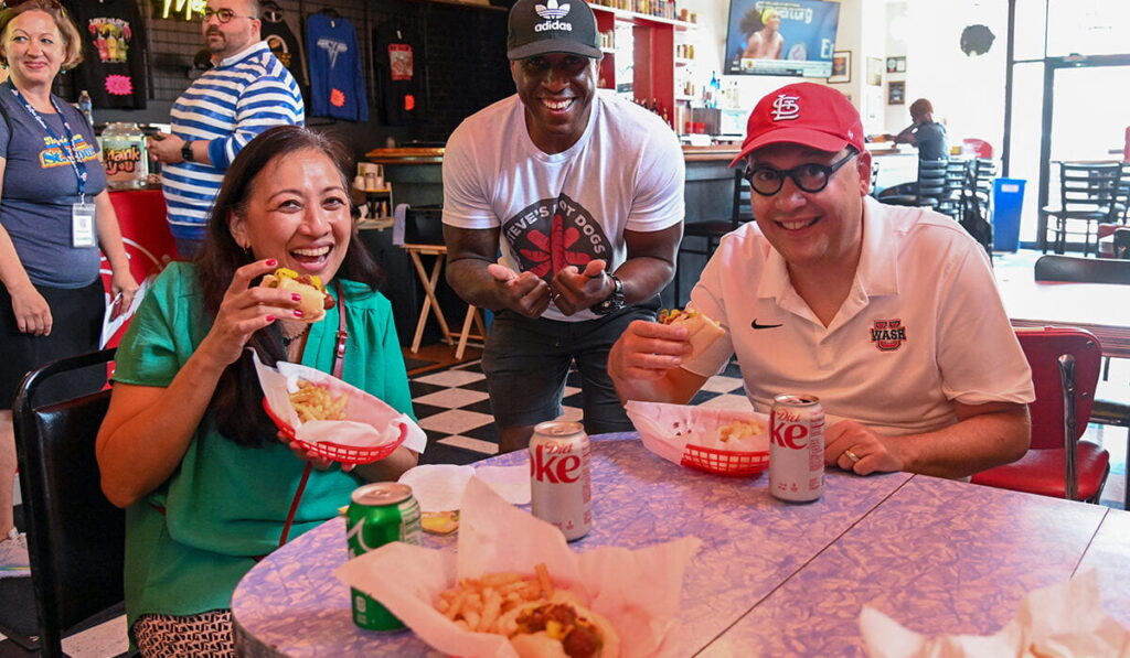 Anna Gonzalez, vice chancellor for student affairs, and Chancellor Andrew D. Martin with Steve Ewing, owner of Steve’s Hot Dogs