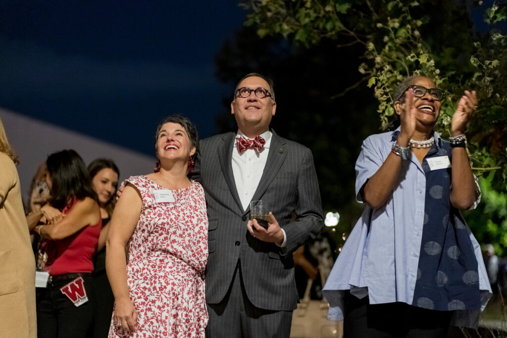 Andrew D. Martin, along with wife Stephanie Martin (left) and university trustee Carrie Johnson enjoy a student ceremony