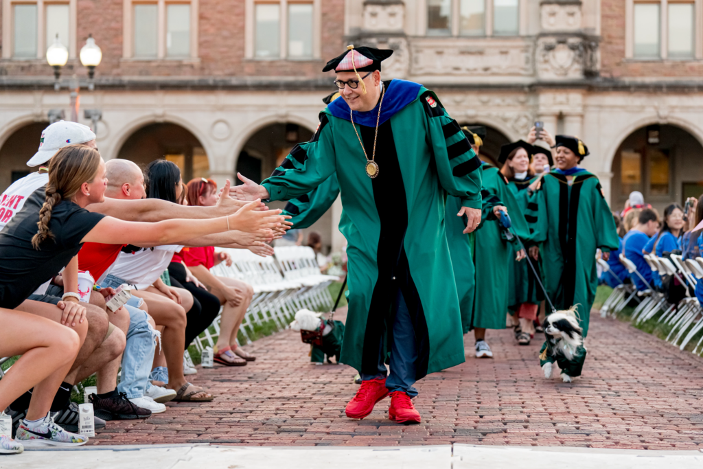 Chancellor Andrew D. Martin gives high fives to students