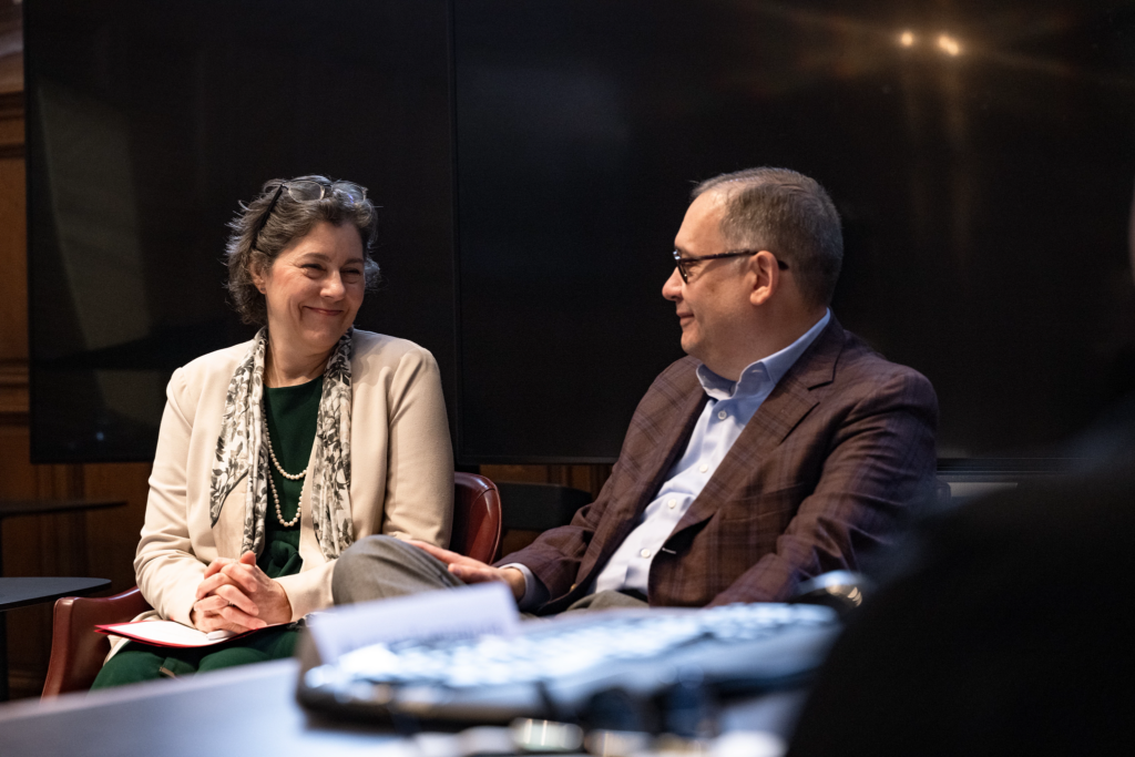 Provost Beverly Wendland and Chancellor Andrew D. Martin sit in chairs having a discussion