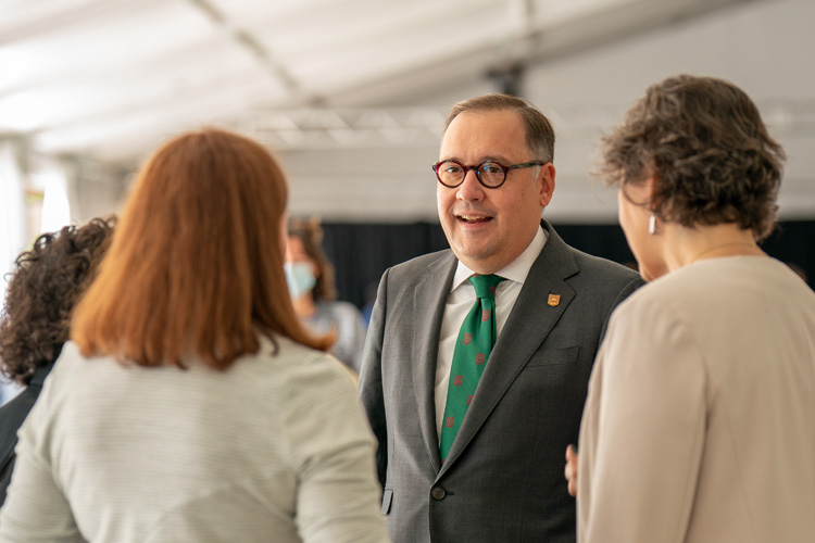 Chancellor Andrew Martin speaks with other guests at event